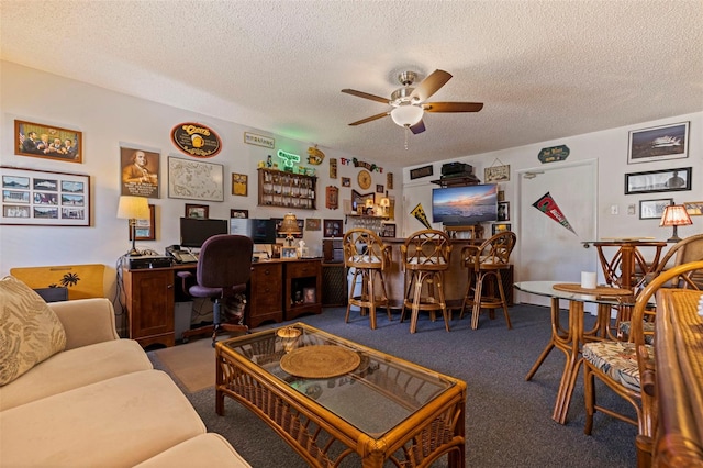 living room with ceiling fan, carpet, and a textured ceiling