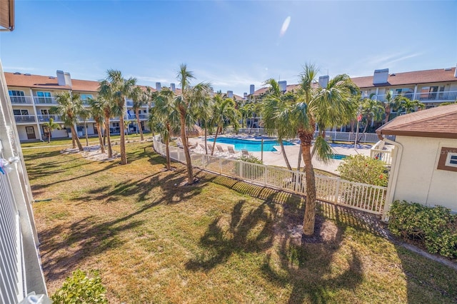 view of pool featuring a yard