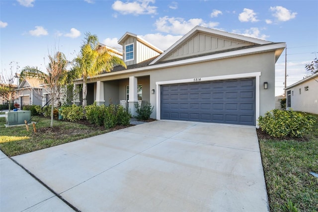 view of front of home featuring a garage, concrete driveway, board and batten siding, and stucco siding