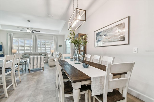 dining area featuring a tray ceiling and ceiling fan