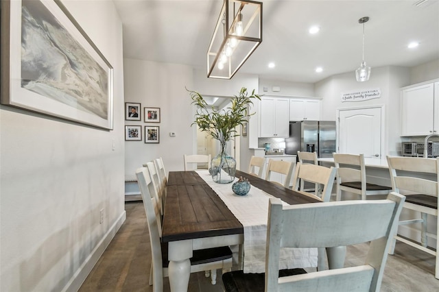 dining space with dark hardwood / wood-style flooring