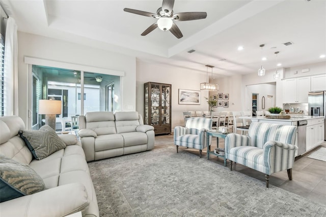 living room with ceiling fan and sink