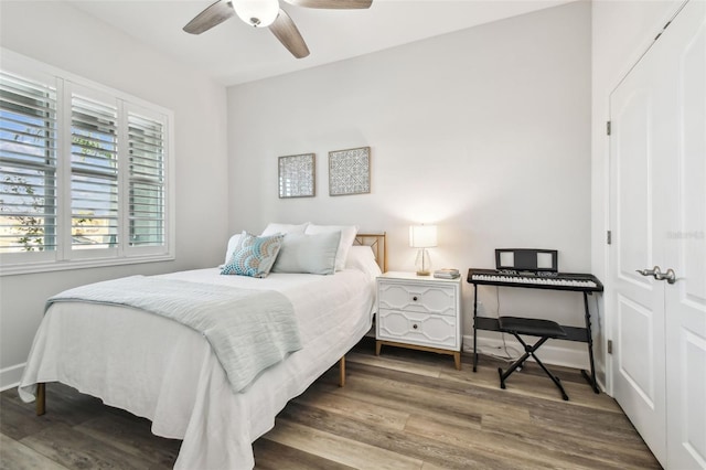 bedroom featuring multiple windows, ceiling fan, and hardwood / wood-style flooring