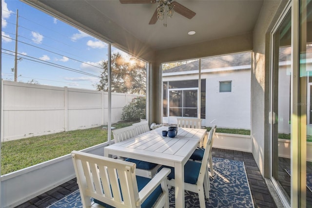 sunroom / solarium featuring a wealth of natural light and ceiling fan