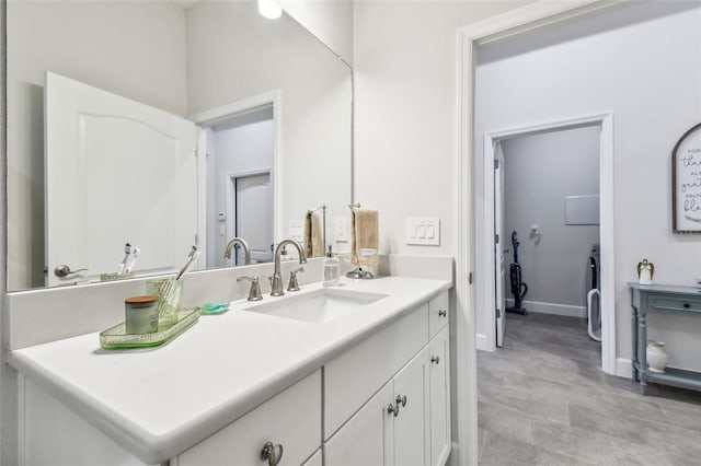 bathroom with vanity and baseboards