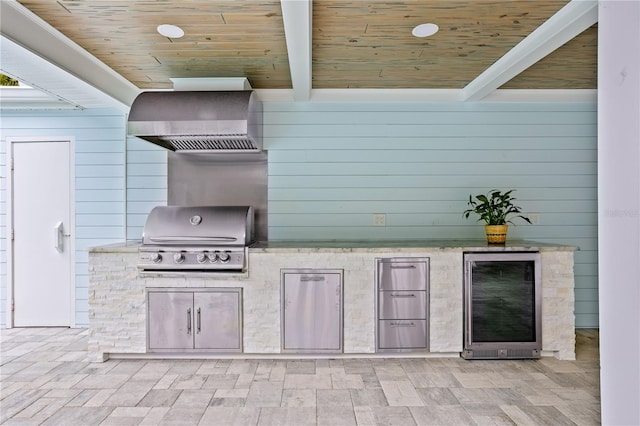 view of patio with area for grilling, exterior kitchen, and beverage cooler