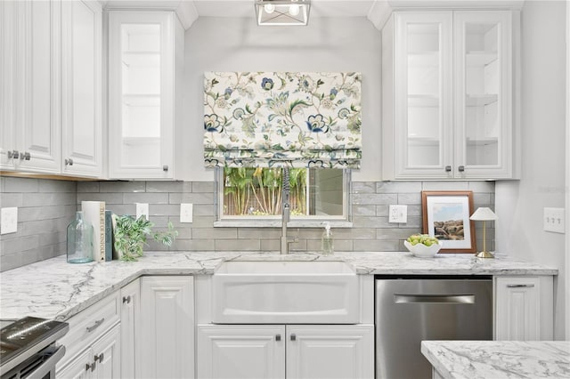 kitchen featuring light stone counters, sink, white cabinets, and dishwasher