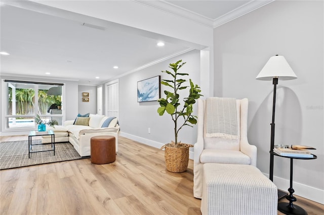 living room featuring light hardwood / wood-style flooring and ornamental molding