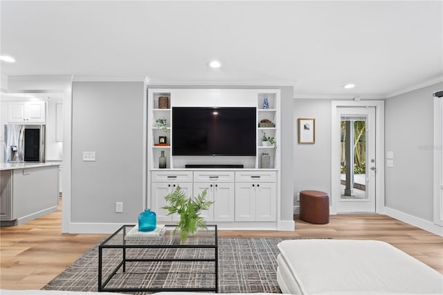 living room with crown molding and light hardwood / wood-style floors