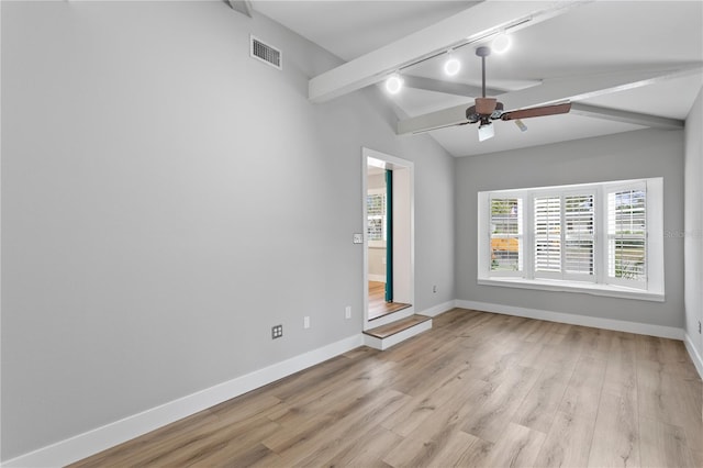 empty room with rail lighting, light hardwood / wood-style floors, vaulted ceiling with beams, and ceiling fan