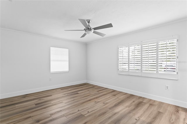 spare room featuring ceiling fan, ornamental molding, and light wood-type flooring