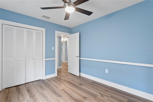 unfurnished bedroom featuring a closet, ceiling fan, and light hardwood / wood-style flooring