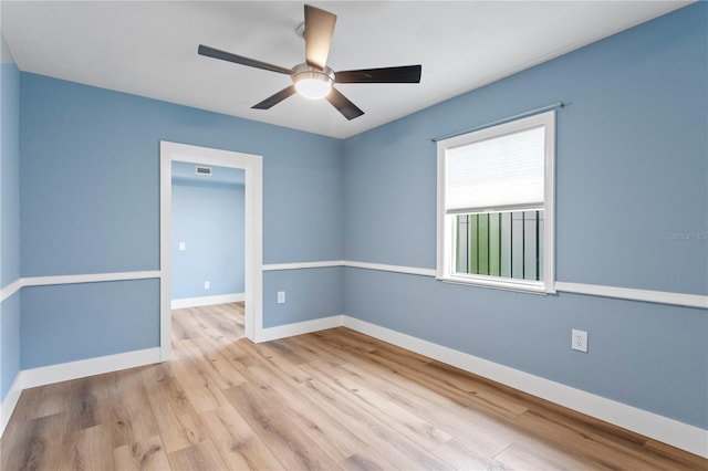 empty room featuring ceiling fan and light hardwood / wood-style floors