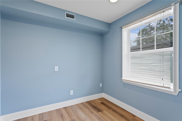 spare room with wood-type flooring