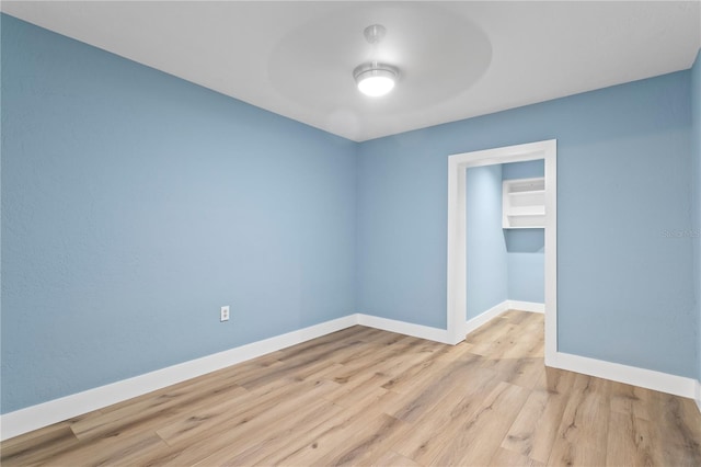 unfurnished room with light wood-type flooring