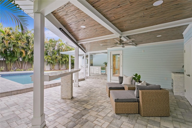 view of patio with ceiling fan and a fenced in pool