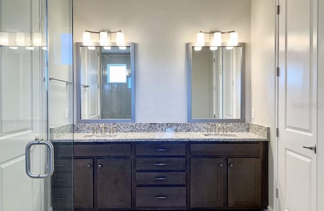 bathroom featuring vanity and an enclosed shower