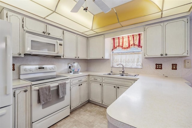 kitchen featuring ceiling fan, white appliances, and sink