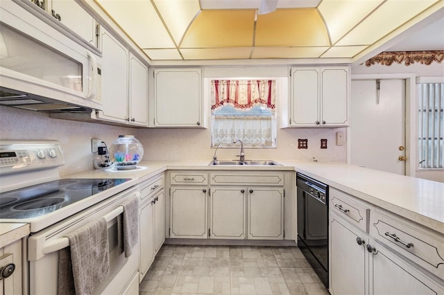 kitchen with a drop ceiling, white cabinetry, white appliances, and sink