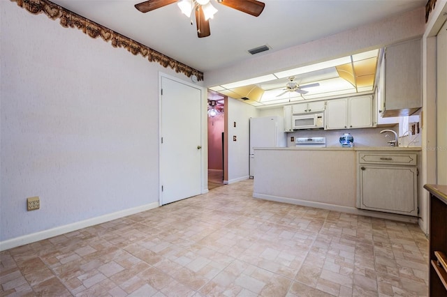 kitchen with ceiling fan, sink, and white appliances