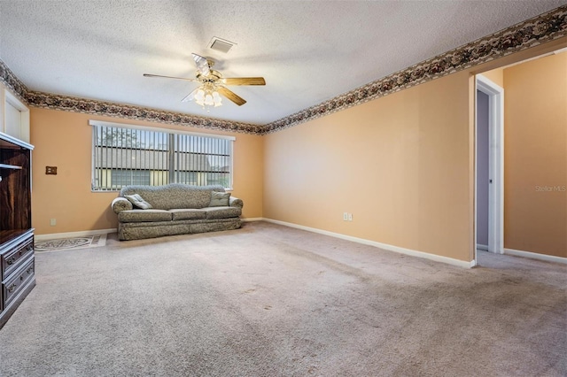 unfurnished living room featuring ceiling fan, carpet floors, and a textured ceiling