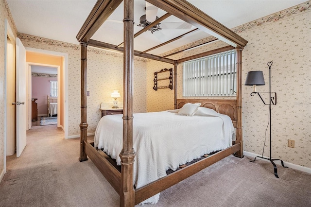 bedroom featuring light carpet and ceiling fan