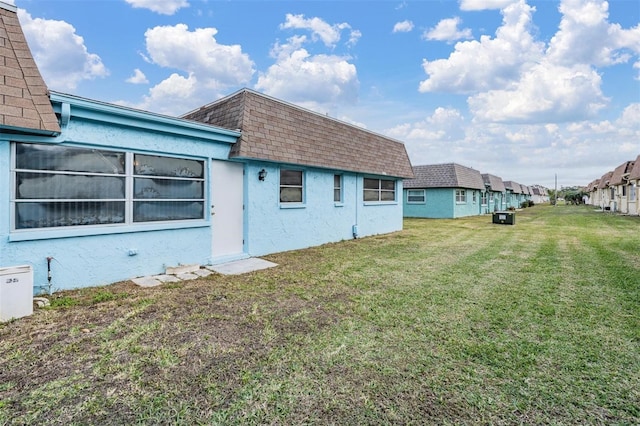 view of side of property with a lawn