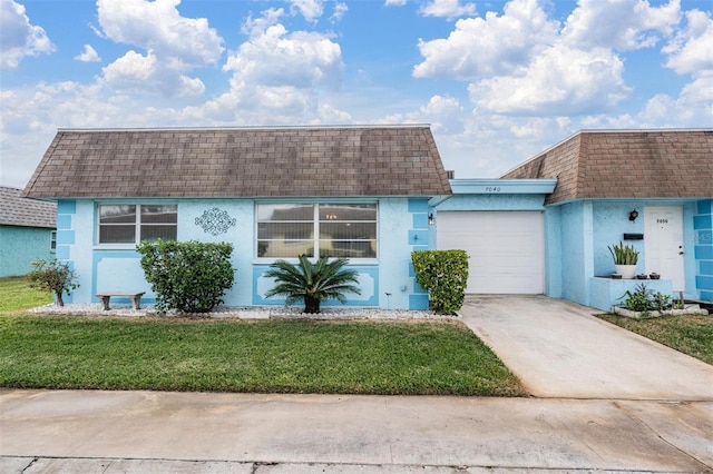 view of front facade with a front yard and a garage