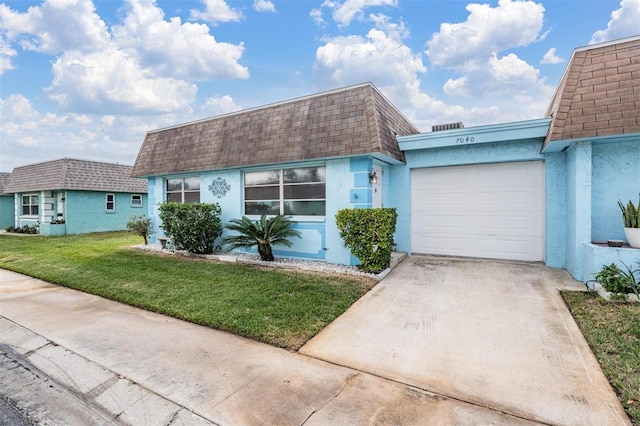 ranch-style home with a garage and a front lawn