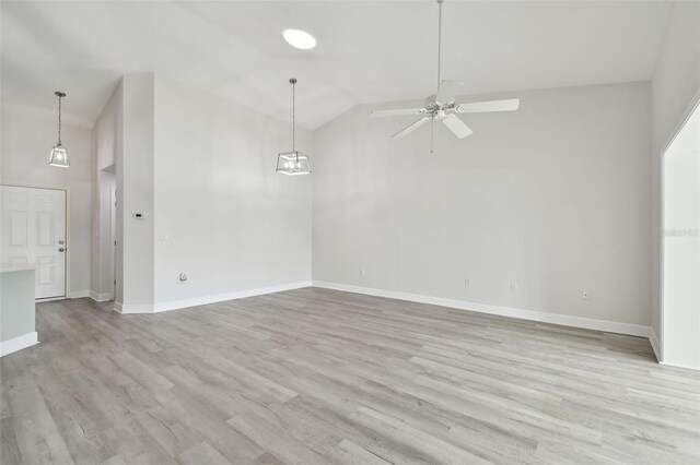 spare room featuring ceiling fan, light hardwood / wood-style floors, and lofted ceiling