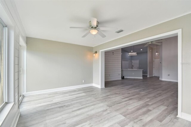 unfurnished living room with ceiling fan and light wood-type flooring