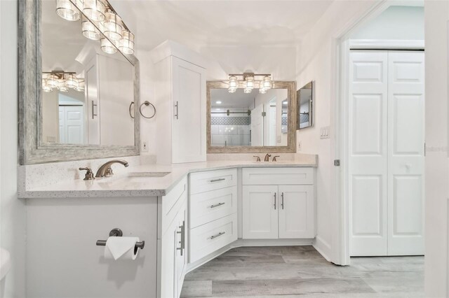 bathroom featuring tasteful backsplash, hardwood / wood-style floors, vanity, and walk in shower