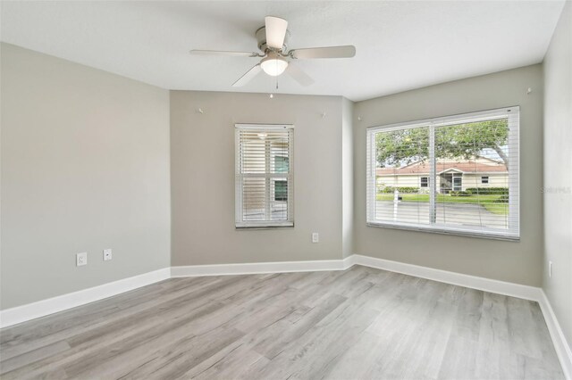 unfurnished room with ceiling fan and light hardwood / wood-style floors