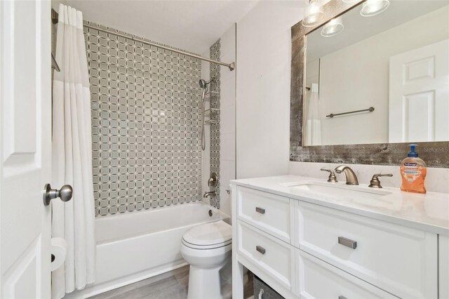 full bathroom with shower / tub combo, vanity, and toilet