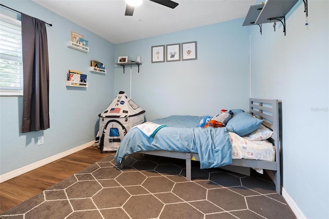 bedroom with ceiling fan and dark hardwood / wood-style flooring