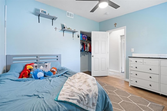 bedroom featuring ceiling fan, a closet, and light hardwood / wood-style flooring