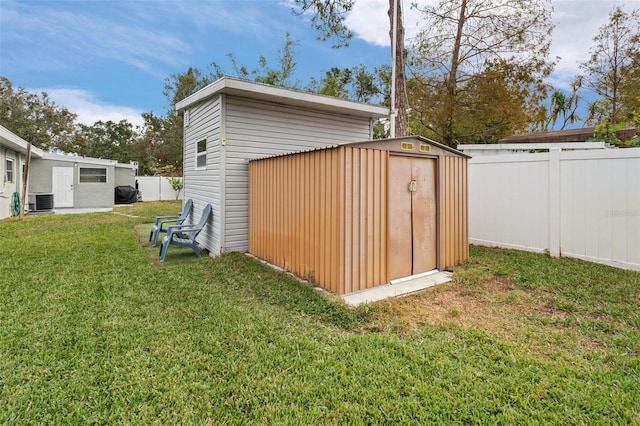 view of outdoor structure with a yard and cooling unit