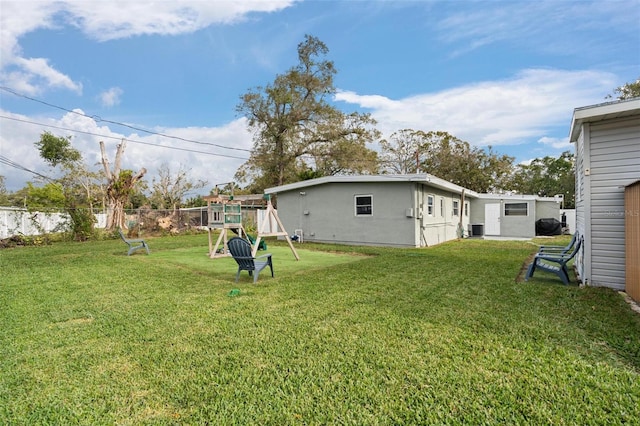 view of yard featuring a playground and central AC unit