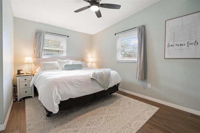 bedroom featuring multiple windows, ceiling fan, and dark hardwood / wood-style floors