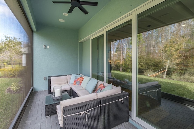 sunroom with ceiling fan