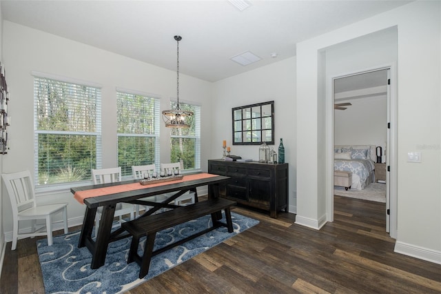 dining room featuring dark hardwood / wood-style floors and an inviting chandelier