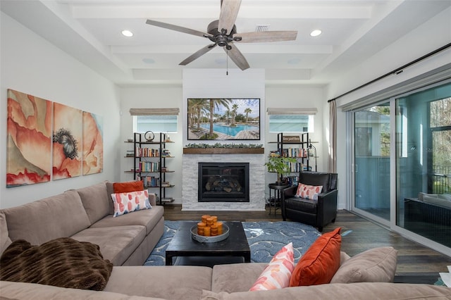 living room featuring ceiling fan, a fireplace, and dark hardwood / wood-style floors