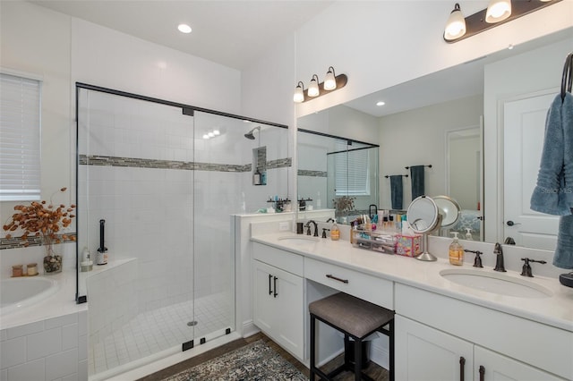 bathroom featuring vanity and shower with separate bathtub