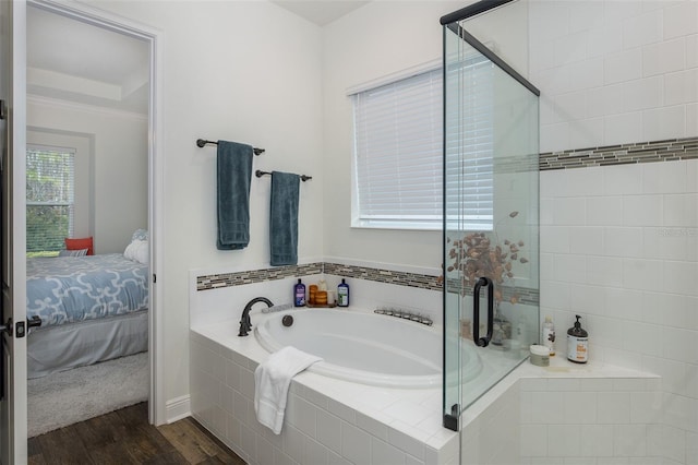 bathroom featuring hardwood / wood-style floors and shower with separate bathtub