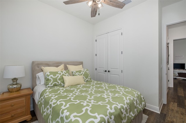 bedroom with dark hardwood / wood-style floors, a closet, and ceiling fan