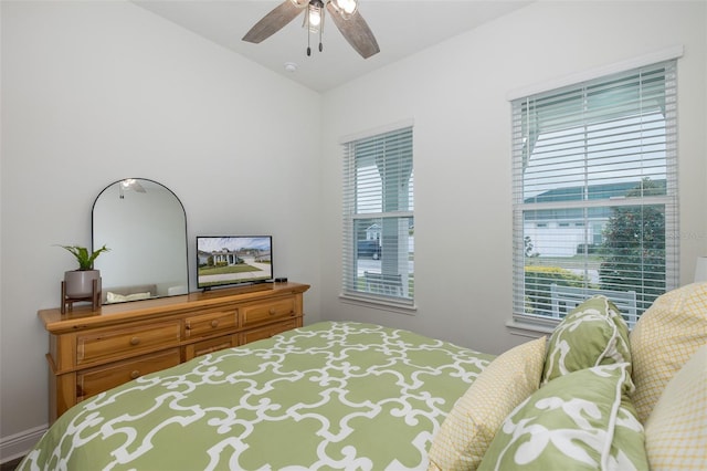 bedroom with multiple windows and ceiling fan