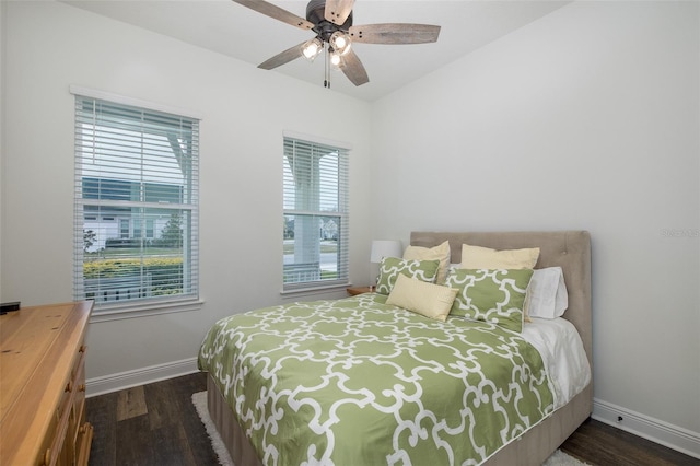 bedroom with ceiling fan, dark hardwood / wood-style floors, and multiple windows