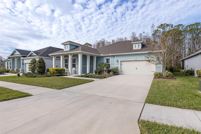 view of front of property featuring a front lawn and a garage