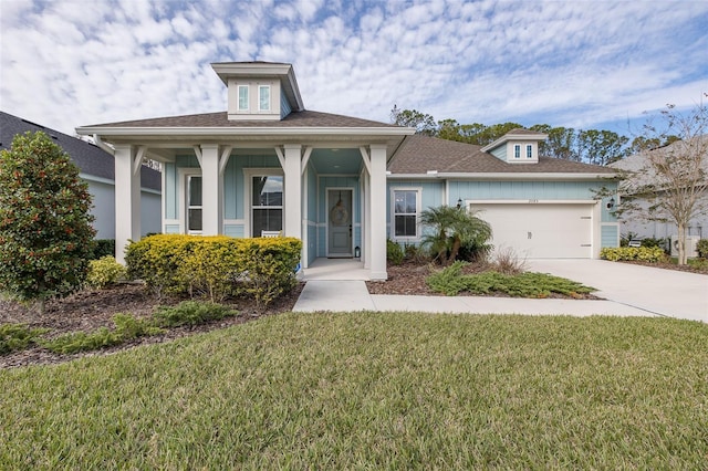 view of front of home with a front yard and a garage