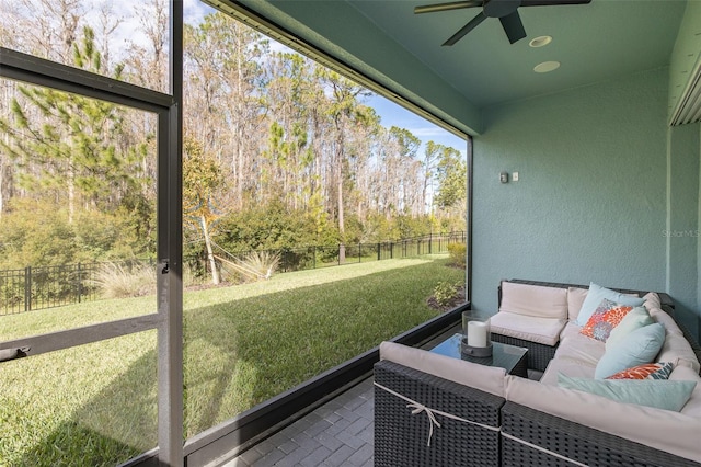 sunroom featuring ceiling fan